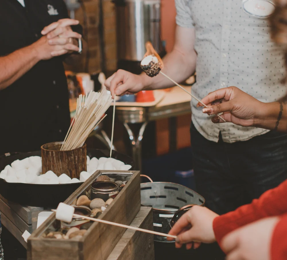 Guests enjoying a S'mores station prepared by City BBQ, showcasing Radius' open vendor partnership.