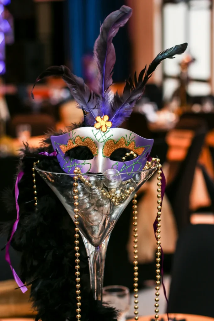 Masquerade mask in a large martini glass