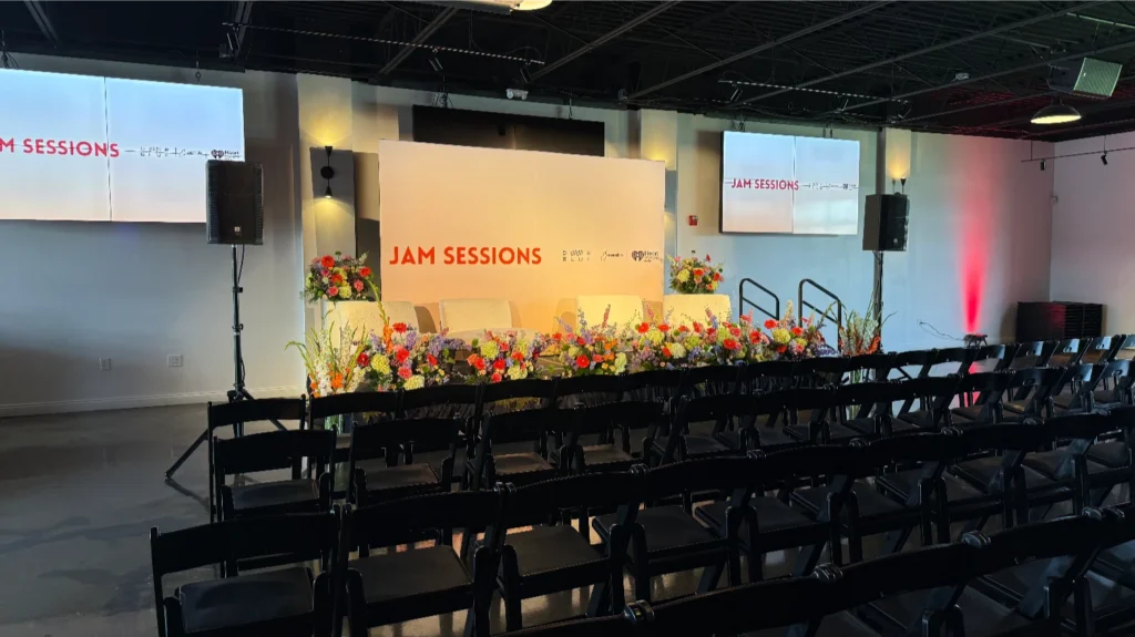 Branded stage setup at an experiential corporate event with immersive lighting and signage