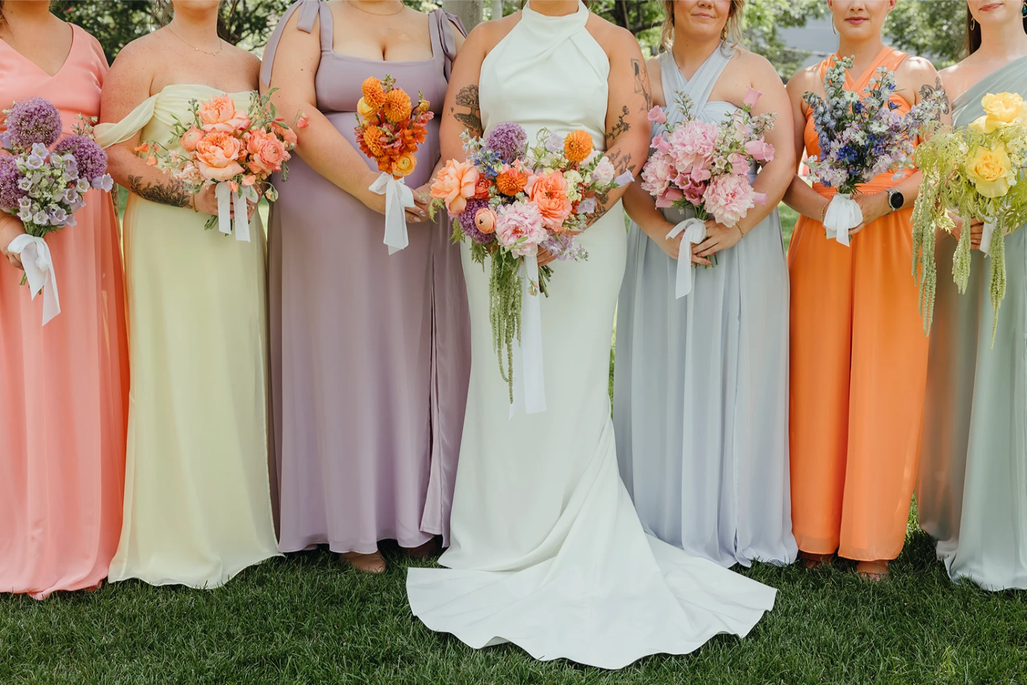 Bride standing with her bridesmaids holding their bouquets at Radius, an Indianapolis wedding venue