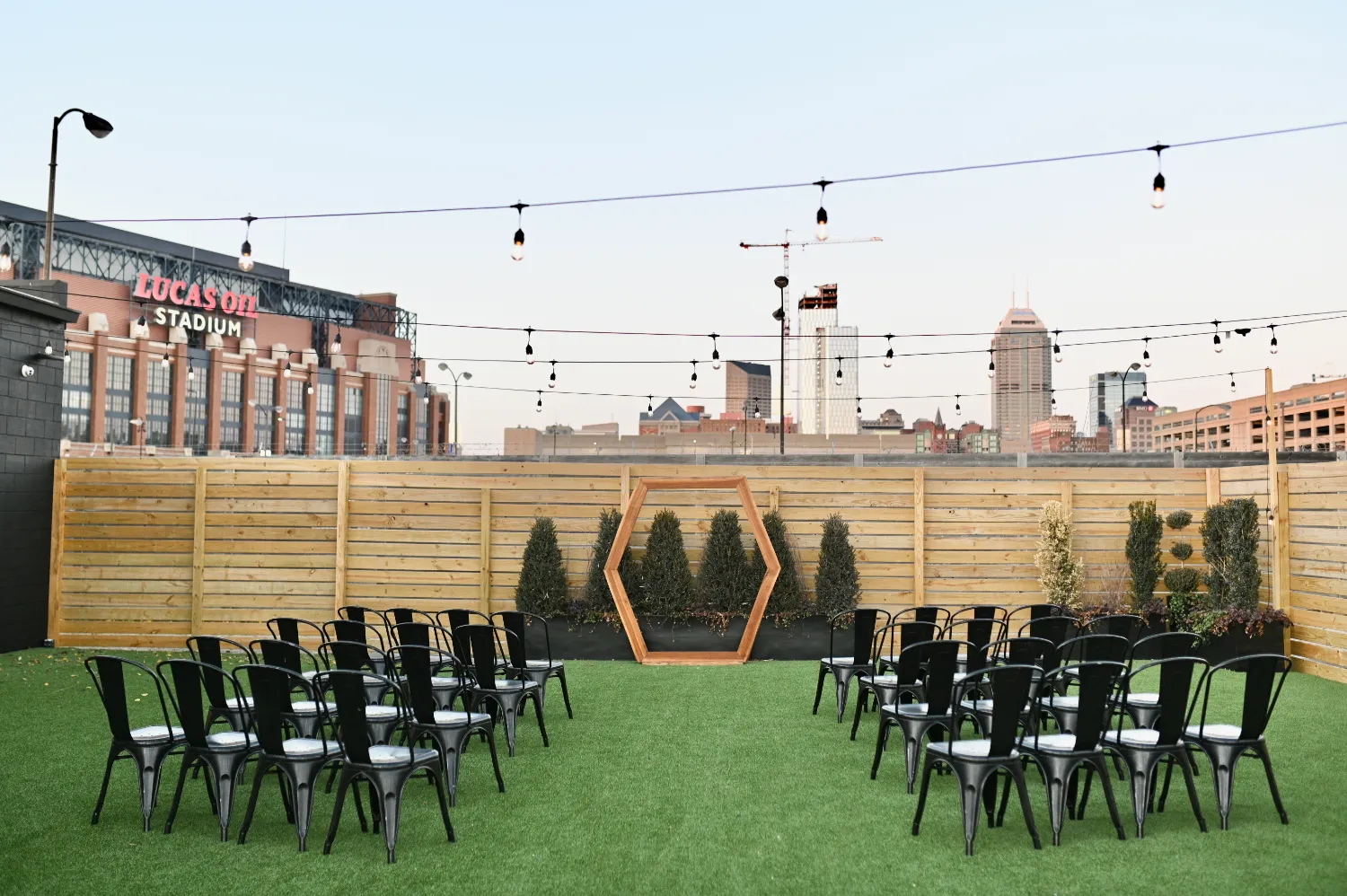 Outdoor wedding setup at Radius, an Indianapolis wedding venue, with Lucas Oil Stadium in the backdrop