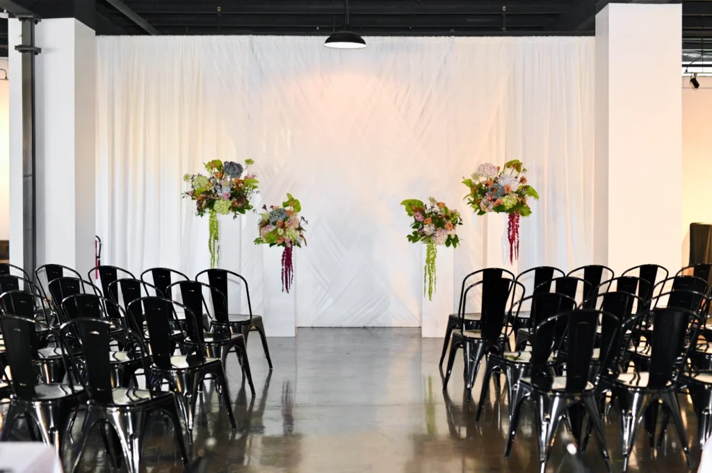 Indianapolis wedding ceremony with white draping and floral pillars