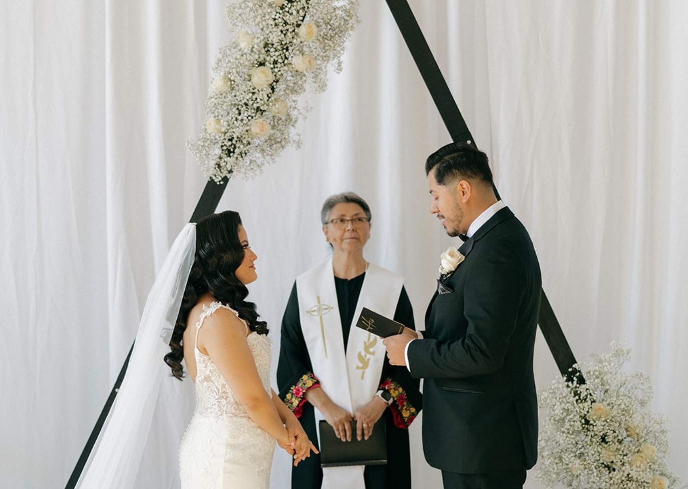 White pipe and drape room divider creating an elegant event setting at Radius Venue